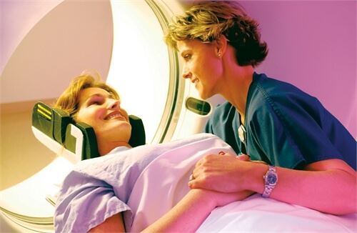 nurse helping woman in a ct scan